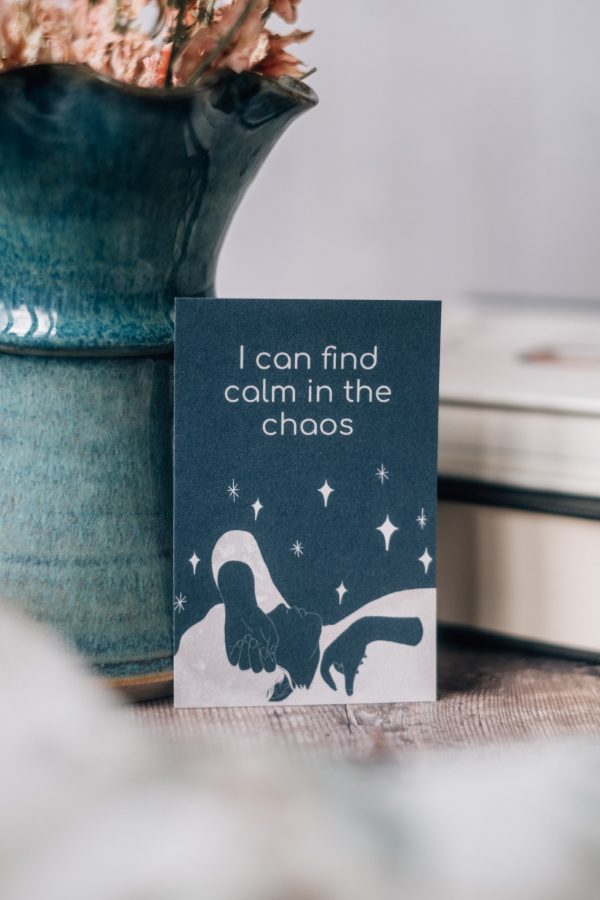 Moon affirmation card with the mantra “i can find calm in the chaos” with a hand drawn illustration of a reclining woman